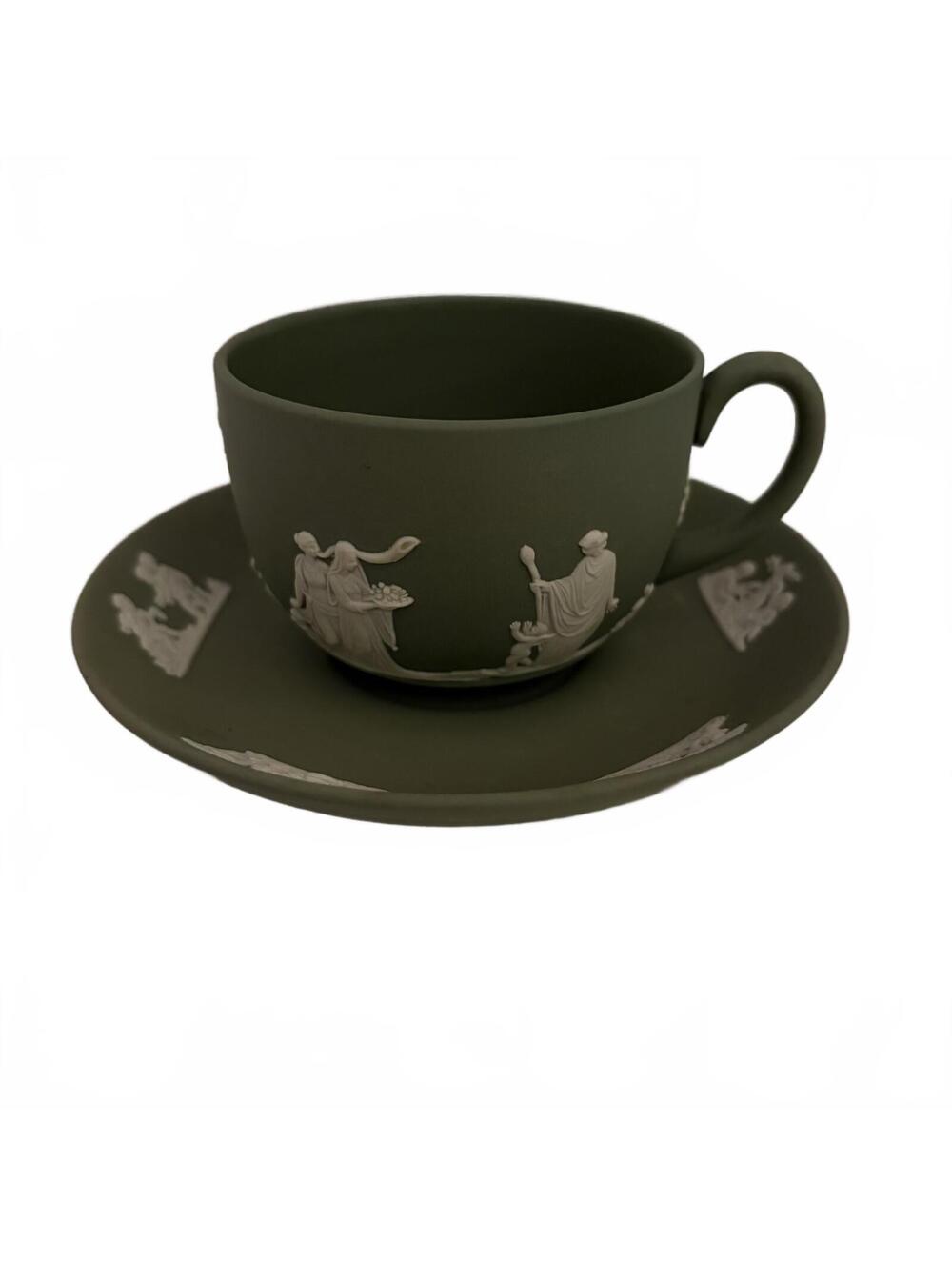 A Wedgwood green Jasperware teacup and saucer with classical relief.